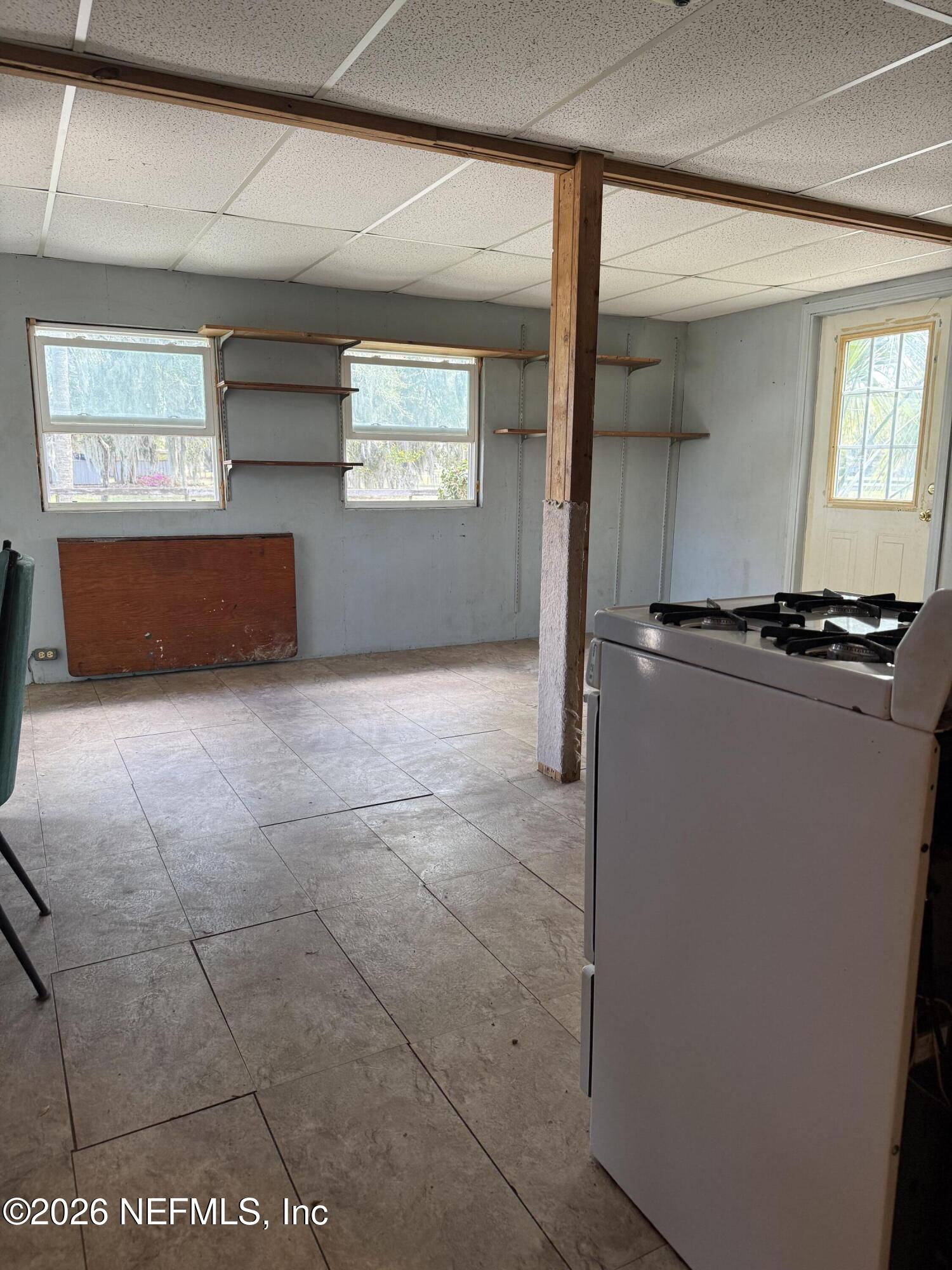 986 Highway 20 Interlachen, FL 32148 - Photo 33 of 53 a kitchen with a stove a refrigerator and a window