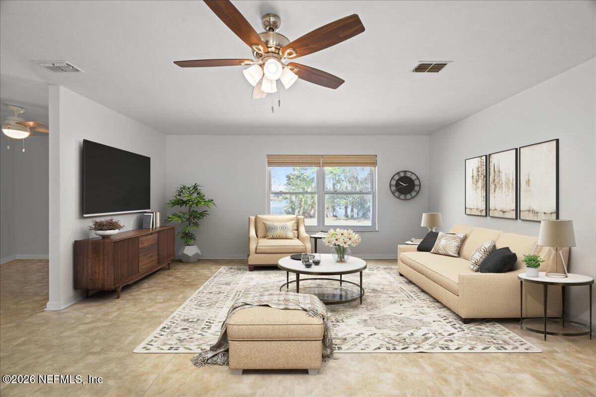 986 Highway 20 Interlachen, FL 32148 - Photo 10 of 48 a living room with furniture and a flat screen tv