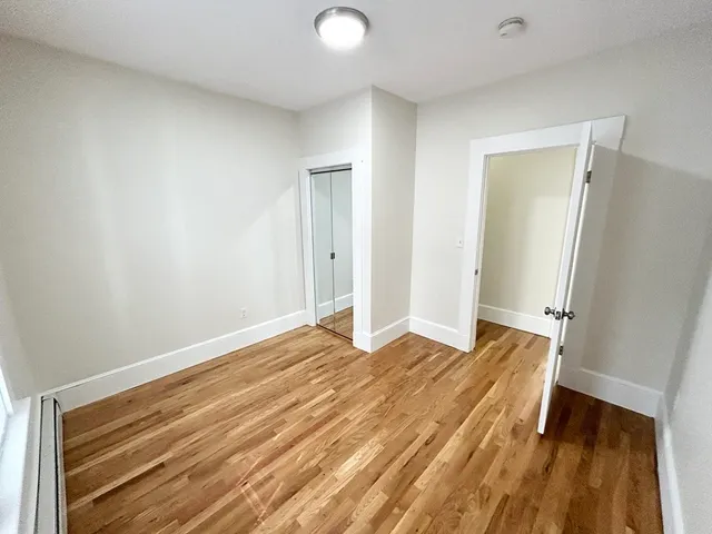 a view of an empty room and wooden floor