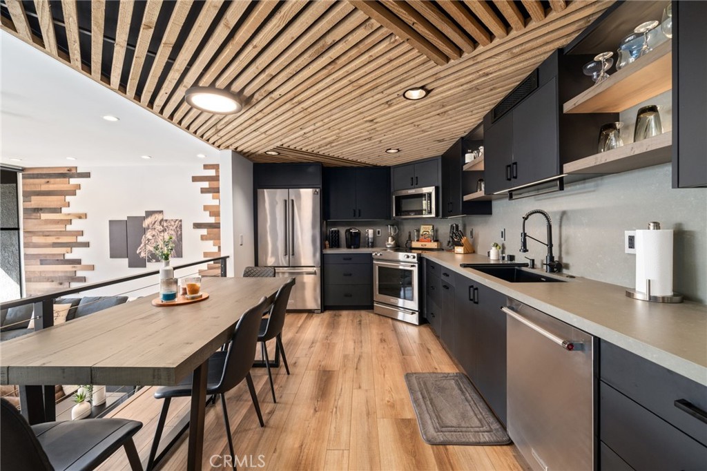 7136 Marina Pacifica Drive Long Beach, CA 90803 - Photo 1 of 3 a kitchen with stainless steel appliances granite countertop lots of counter top space and stainless steel appliances