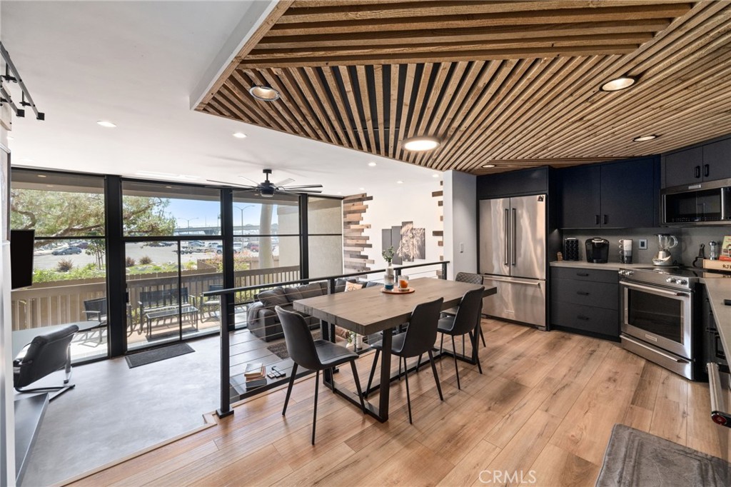 7136 Marina Pacifica Drive Long Beach, CA 90803 - Photo 3 of 3 a kitchen with stainless steel appliances granite countertop a kitchen island hardwood floor and a sink