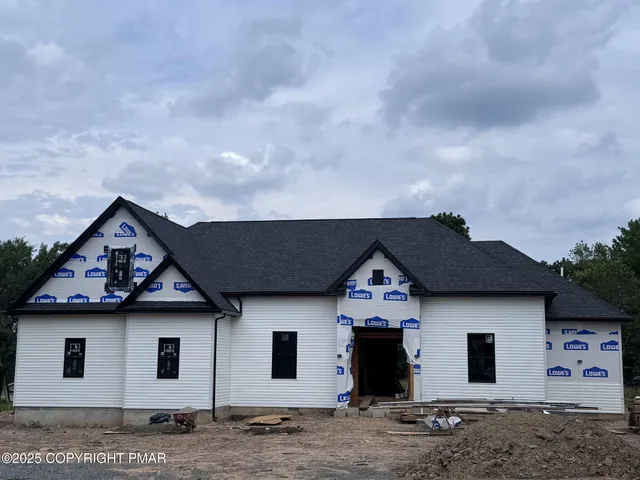 a front view of a house with a wooden fence