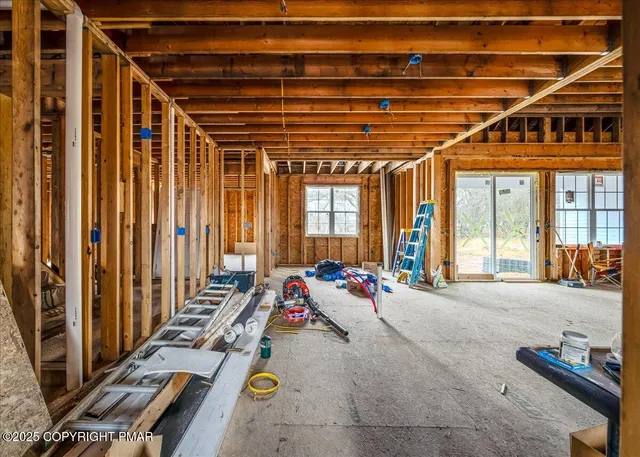 a view of a porch with furniture and floor to ceiling window