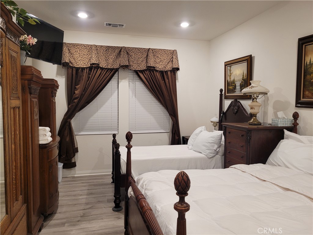 7561 Baerss Road Riverside, CA 92507 - Photo 12 of 27 a living room with couches and kitchen view with wooden floor