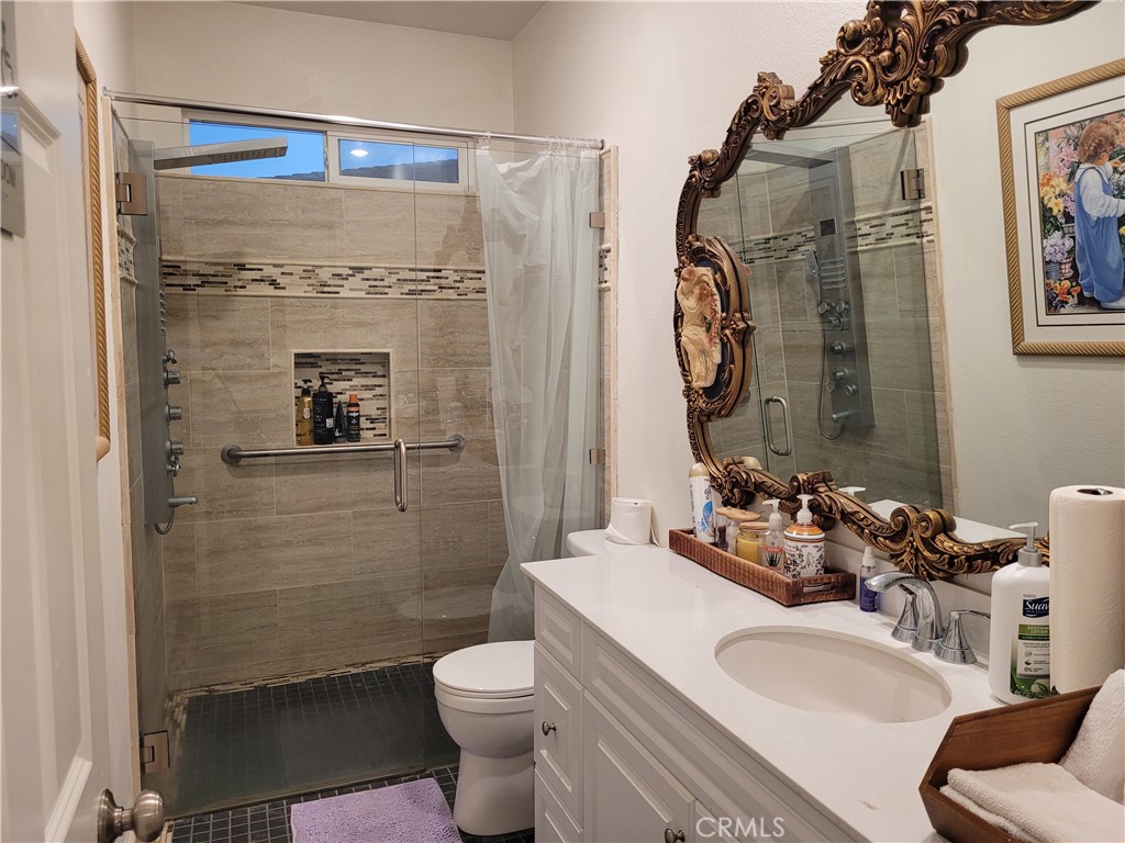 7561 Baerss Road Riverside, CA 92507 - Photo 16 of 27 a bathroom with a sink toilet and shower