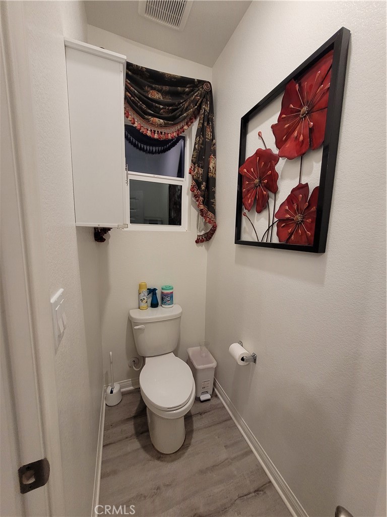 7561 Baerss Road Riverside, CA 92507 - Photo 20 of 27 a white toilet sitting next to a small bathroom