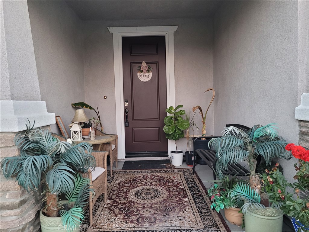 7561 Baerss Road Riverside, CA 92507 - Photo 3 of 27 a potted plant sitting in front of a house