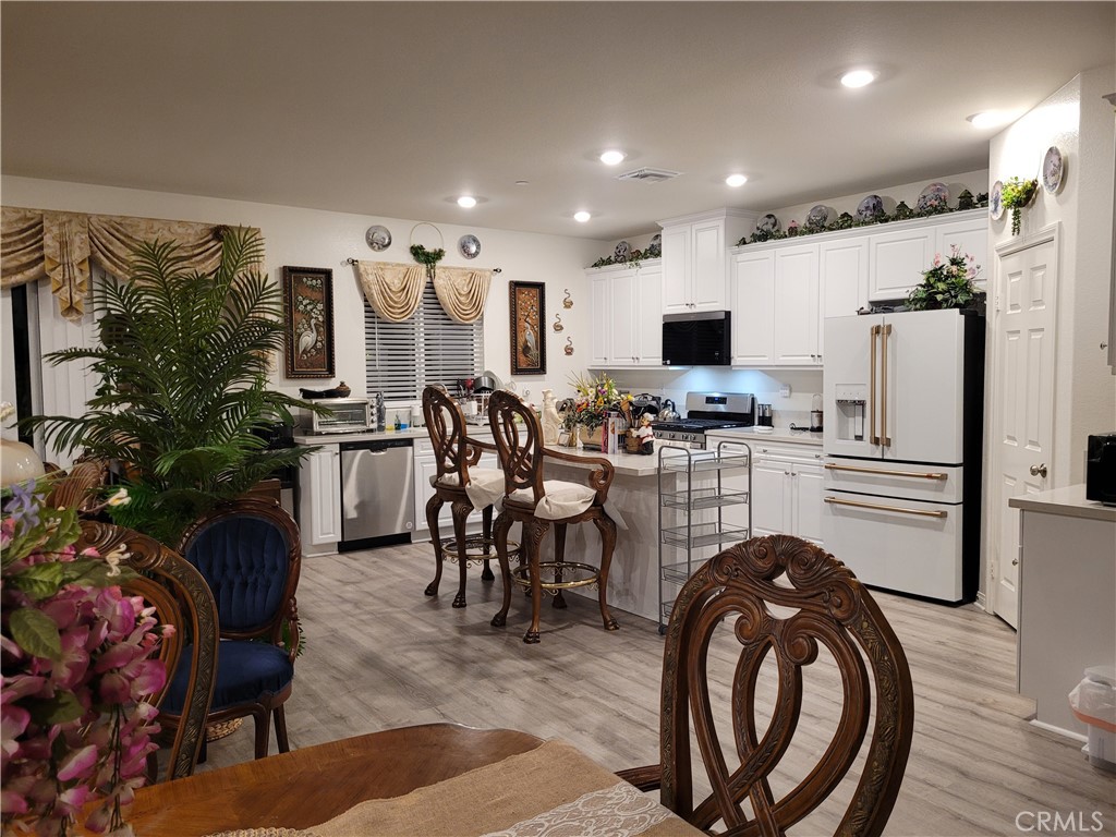 7561 Baerss Road Riverside, CA 92507 - Photo 9 of 27 a kitchen with stainless steel appliances kitchen island granite countertop a refrigerator and microwave