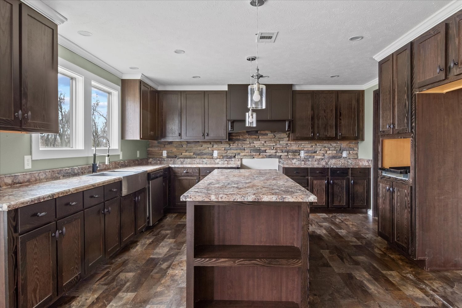 1189 Chicken Creek Road Pulaski, TN 38478 - Photo 6 of 30 a kitchen with kitchen island granite countertop wooden cabinets a refrigerator and a sink