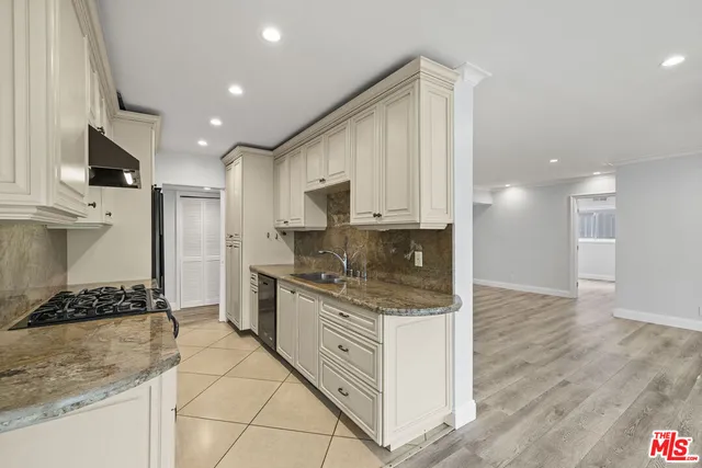 a kitchen with stainless steel appliances granite countertop a stove and a sink