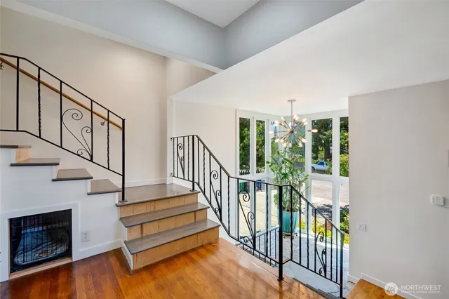 a view of staircase with wooden floor and a fireplace