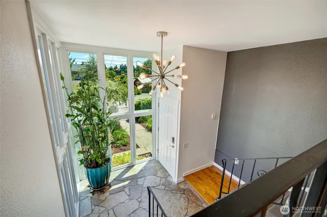 a view of hallway with furniture and a potted plant