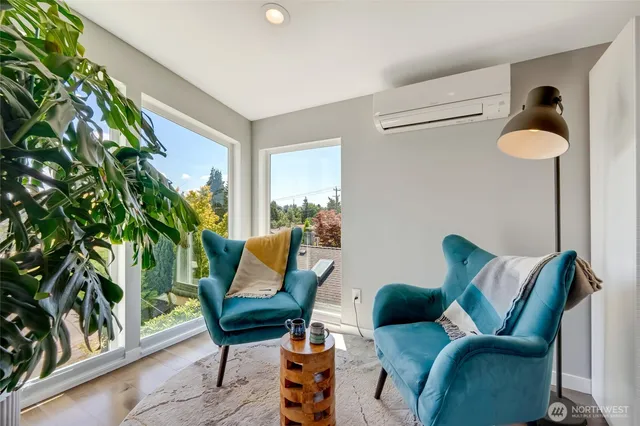 a living room with furniture and a potted plant