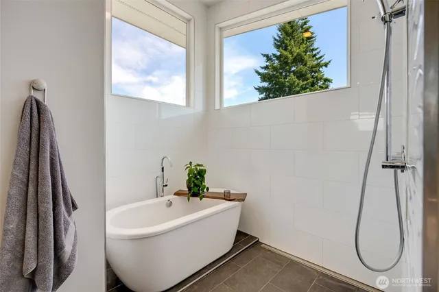 a bathroom with a tub and shower