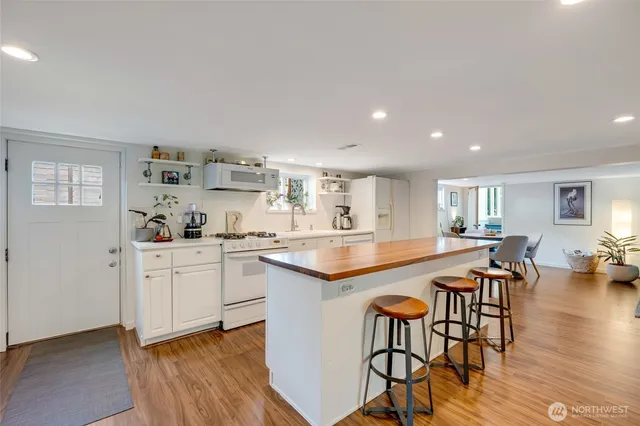 a large kitchen with a table and chairs in it