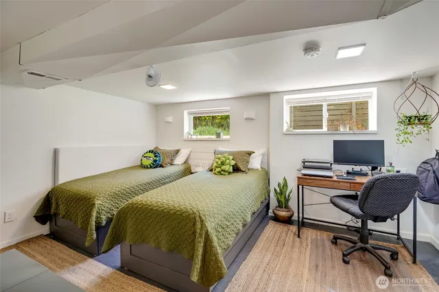 a bedroom with a bed and a desk