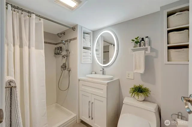 a bathroom with a sink toilet and shower