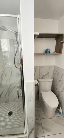 a white toilet sitting next to a bathroom sink