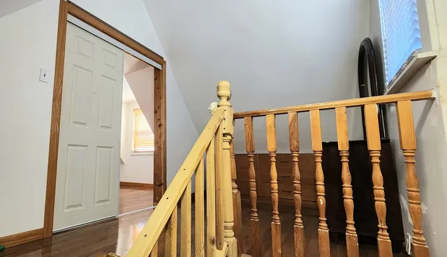 a view of entryway and hall with wooden floor