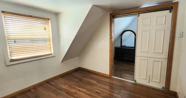 a bedroom with a bed and lamp with window