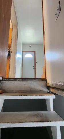 a view of a storage and utility room with refrigerator washer and dryer