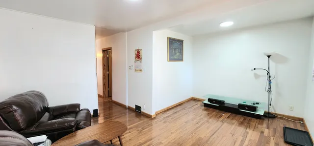 a view of a hardwood floor and workspace in a room