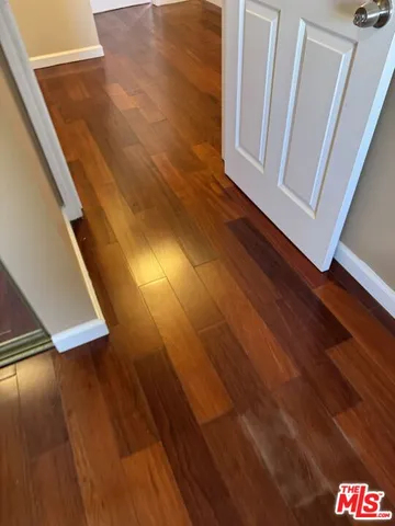 a view of an empty room and wooden floor