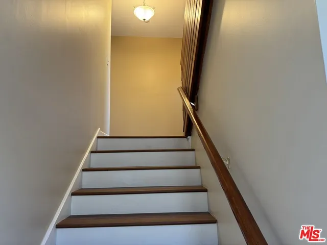 a view of empty room with window and wooden floor