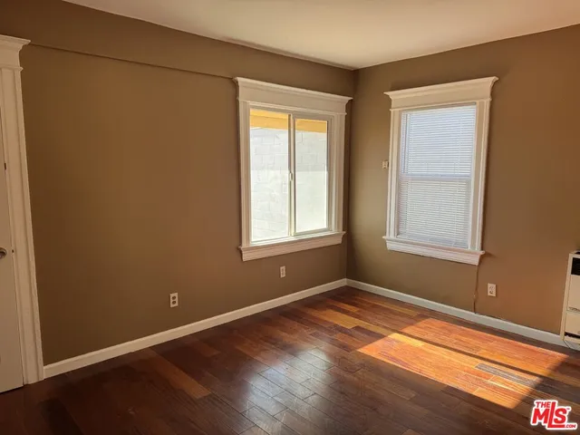 a view of livingroom with hardwood floor and front door