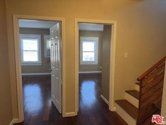 a kitchen with granite countertop a sink and white cabinets