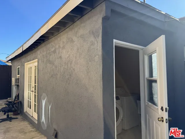 an entryway door with wooden floor