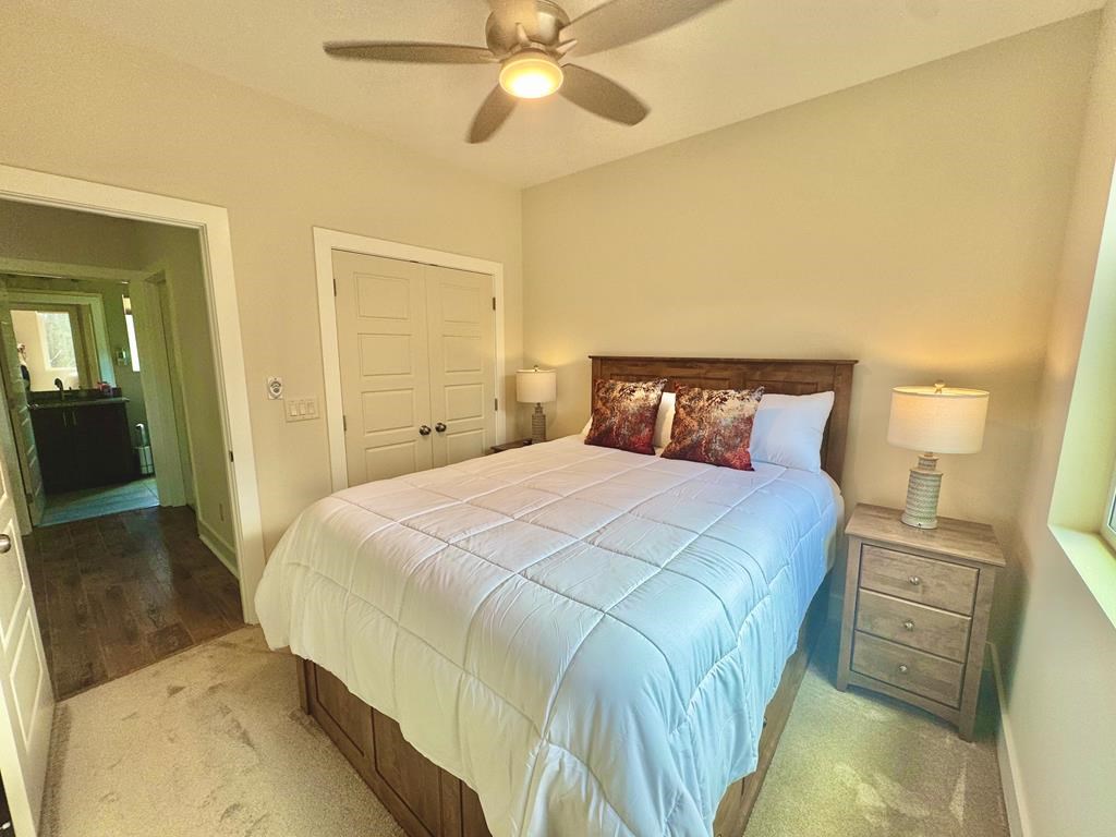 1001 Sunset Road Epworth, GA 30541 - Photo 11 of 34 a bedroom with a bed and a chandelier