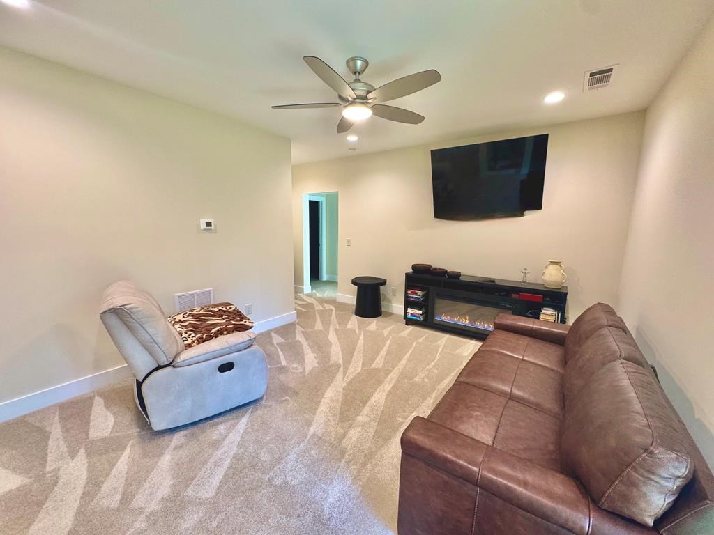 1001 Sunset Road Epworth, GA 30541 - Photo 13 of 34 a living room with furniture and a flat screen tv
