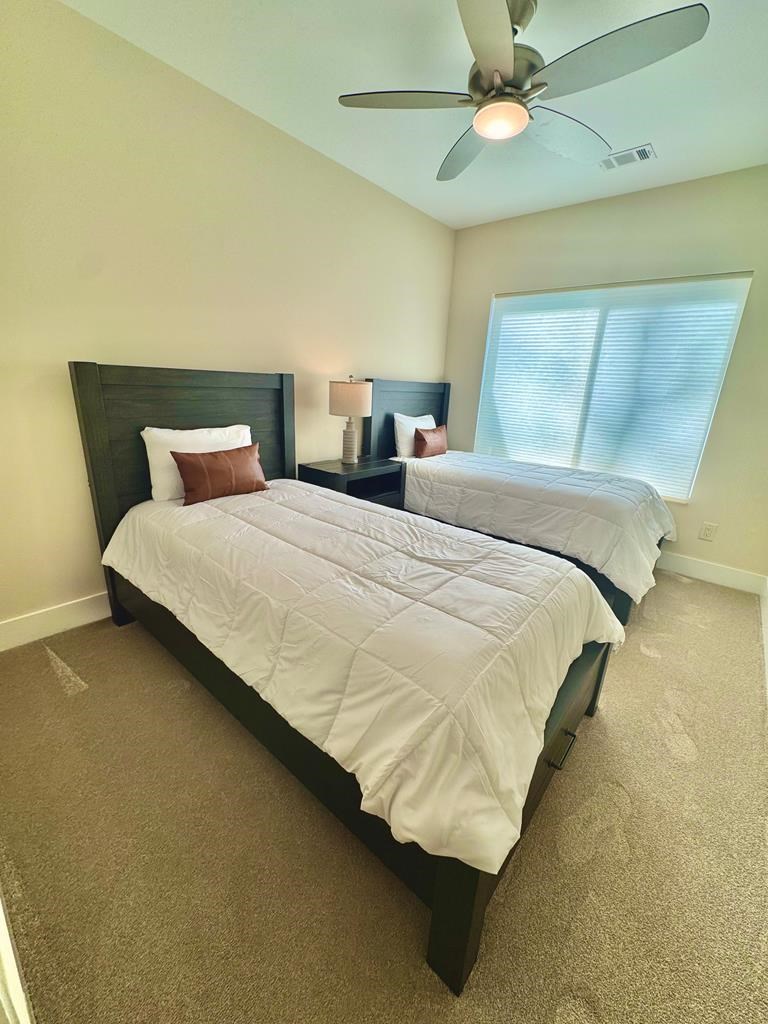 1001 Sunset Road Epworth, GA 30541 - Photo 15 of 34 a bedroom with a bed and ceiling fan