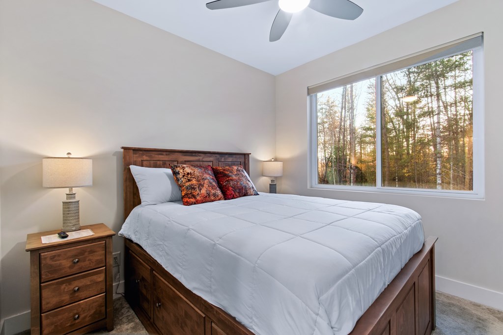 1001 Sunset Road Epworth, GA 30541 - Photo 29 of 34 a bedroom with a bed and a lamp on dresser