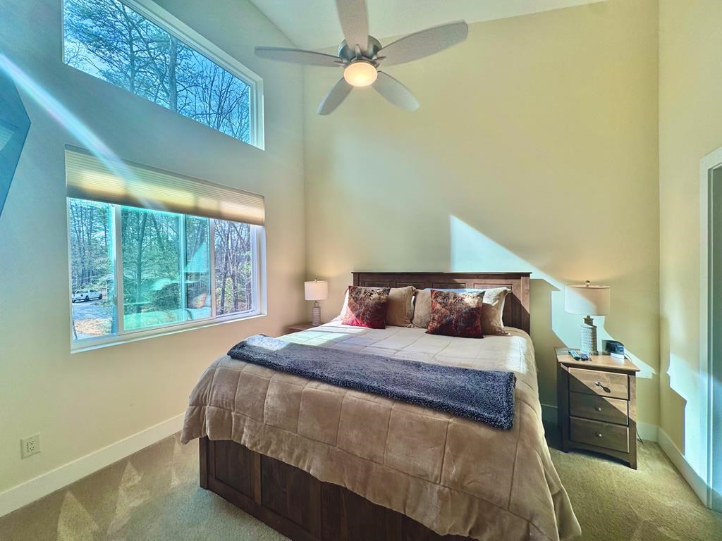 1001 Sunset Road Epworth, GA 30541 - Photo 7 of 34 a bedroom with a large bed and a chandelier