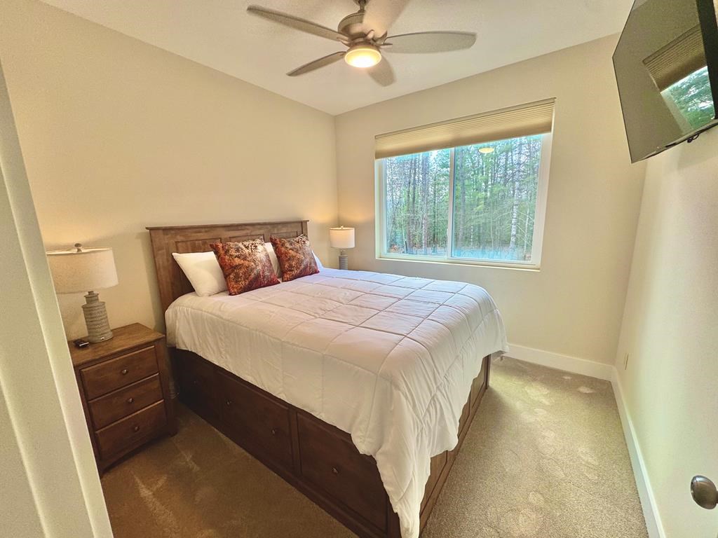 1001 Sunset Road Epworth, GA 30541 - Photo 10 of 34 a bedroom with a bed and a chandelier