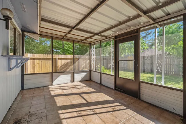 a spacious bathroom with a tub and large windows