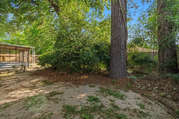 a view of a house with a tree in the background