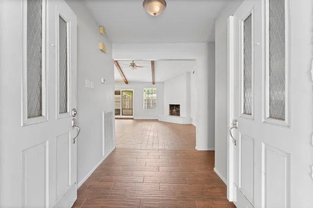 a view of a hallway with wooden floor