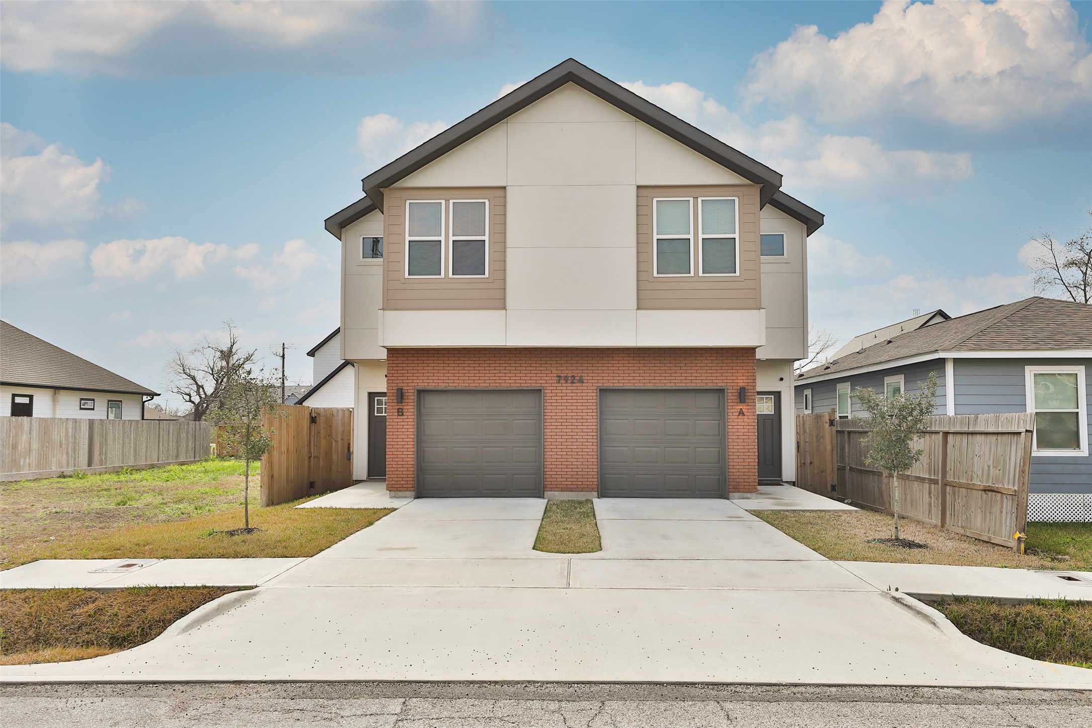 7924 Booker Street, Unit B Houston, TX 77028 - Photo 1 of 19 a front view of a house with a yard and garage