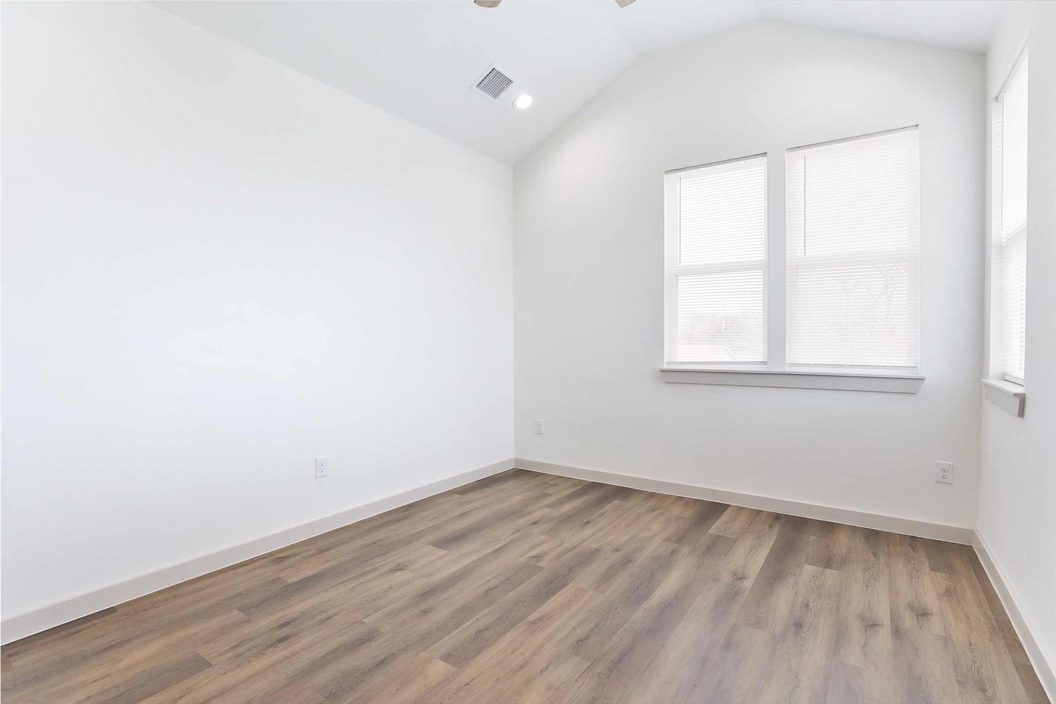 7924 Booker Street, Unit B Houston, TX 77028 - Photo 9 of 19 an empty room with wooden floor and windows