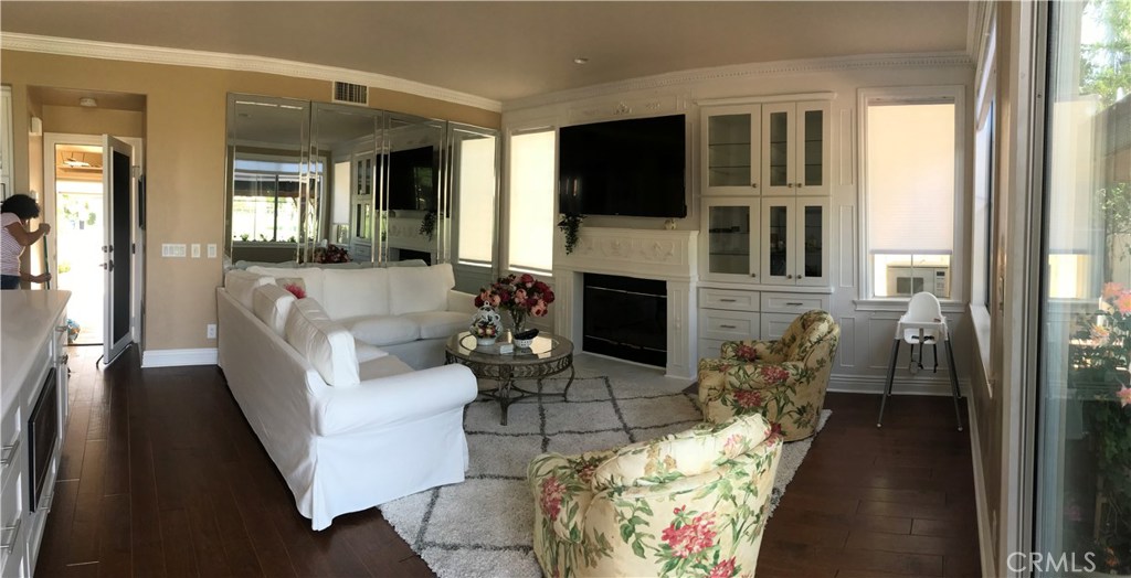 12823 Maxwell Drive Tustin, CA 92782 - Photo 15 of 25 a living room with furniture a flat screen tv and a fireplace