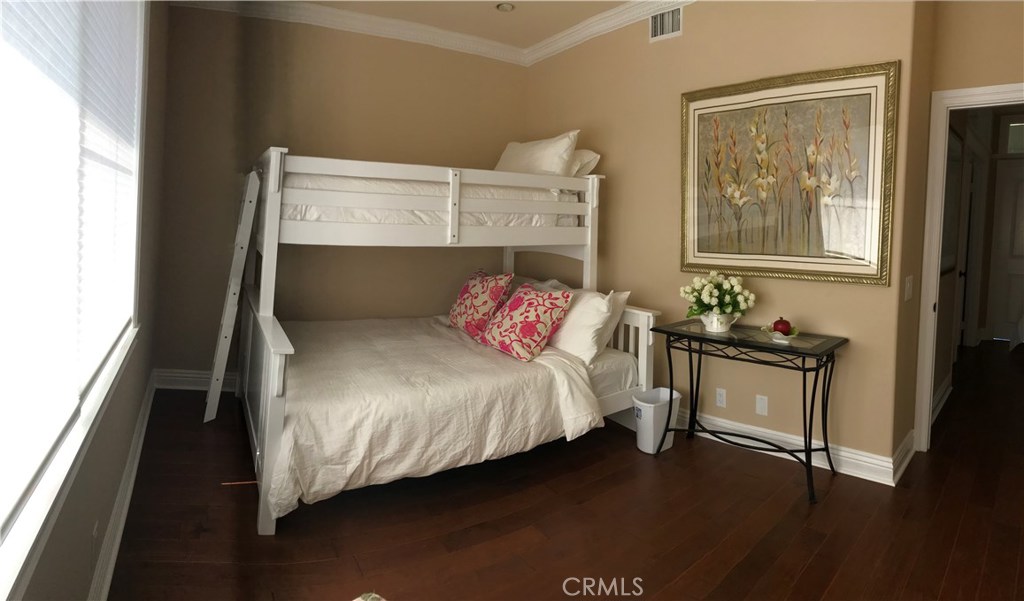 12823 Maxwell Drive Tustin, CA 92782 - Photo 3 of 25 a bedroom with a bed and wooden floor