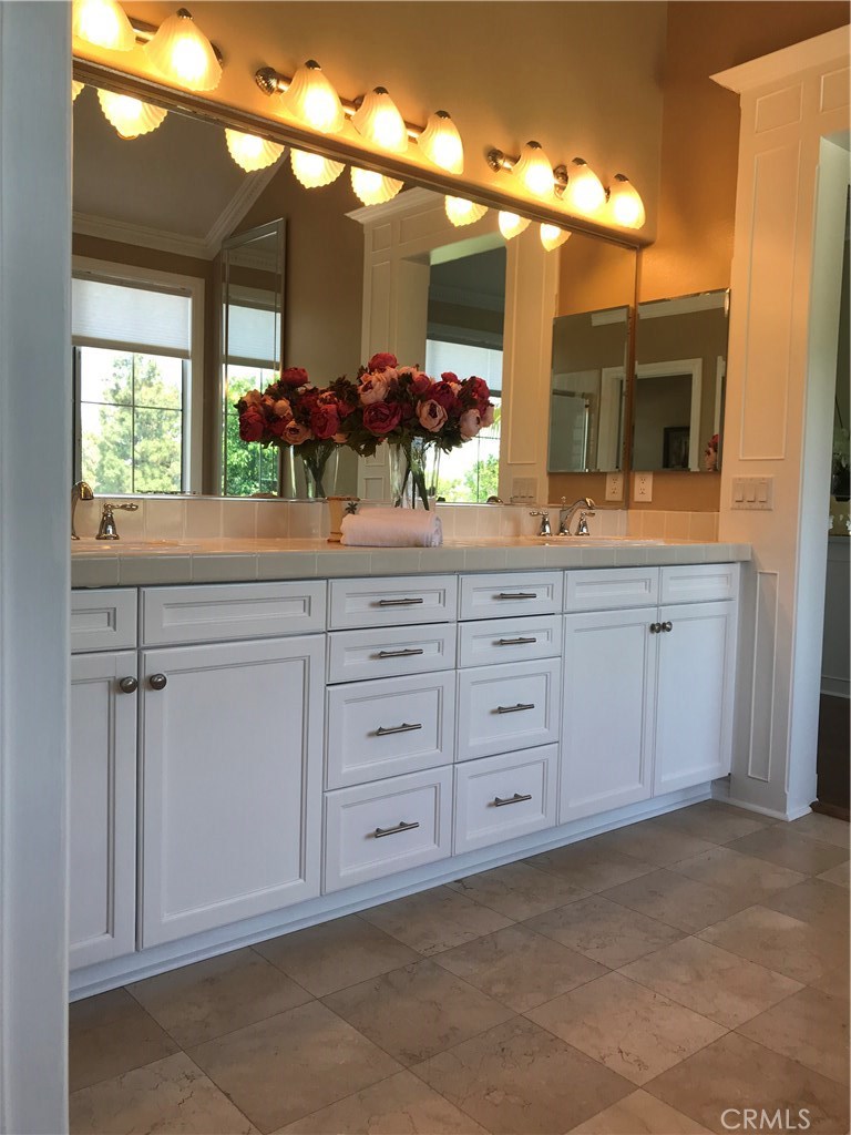 12823 Maxwell Drive Tustin, CA 92782 - Photo 9 of 25 a bathroom with a sink and large mirror