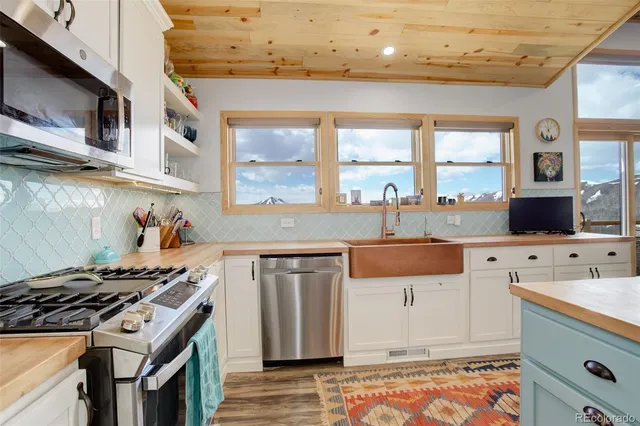 an aerial view of a house with a yard and lake view