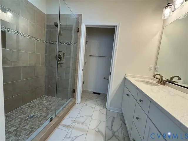 a bathroom with a shower sink and mirror