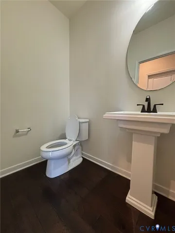 a white toilet sitting next to a bathroom sink