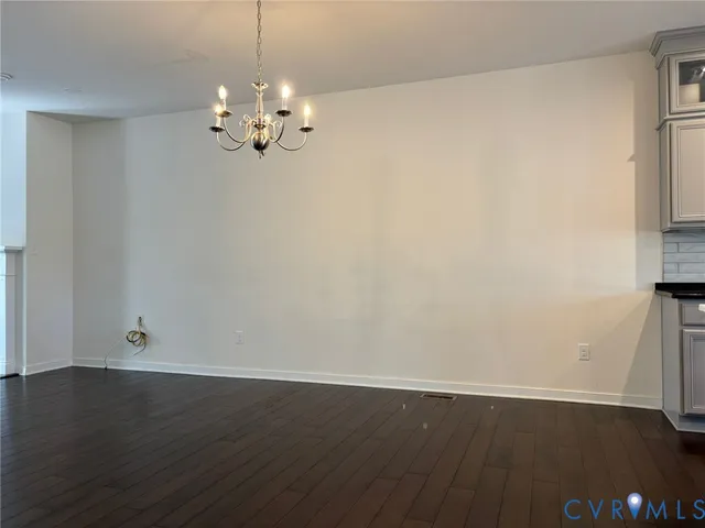 a view of a chandelier fan and wooden floor