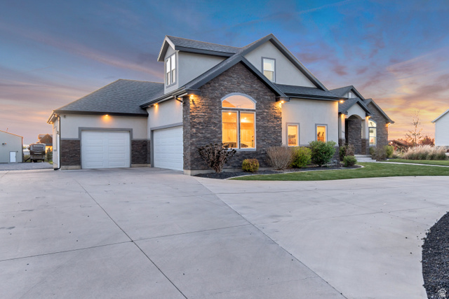 1526 South 500 West Mapleton, UT 84664 - Photo 40 of 54 View of front of property featuring stucco siding, stone siding, concrete driveway, and an attached garage